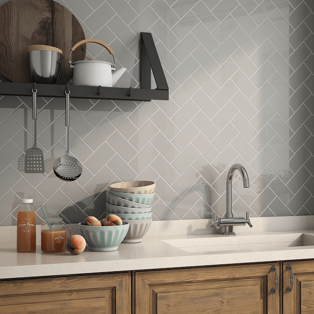 Subway tile on a kitchen backsplash laid out in a herringbone pattern