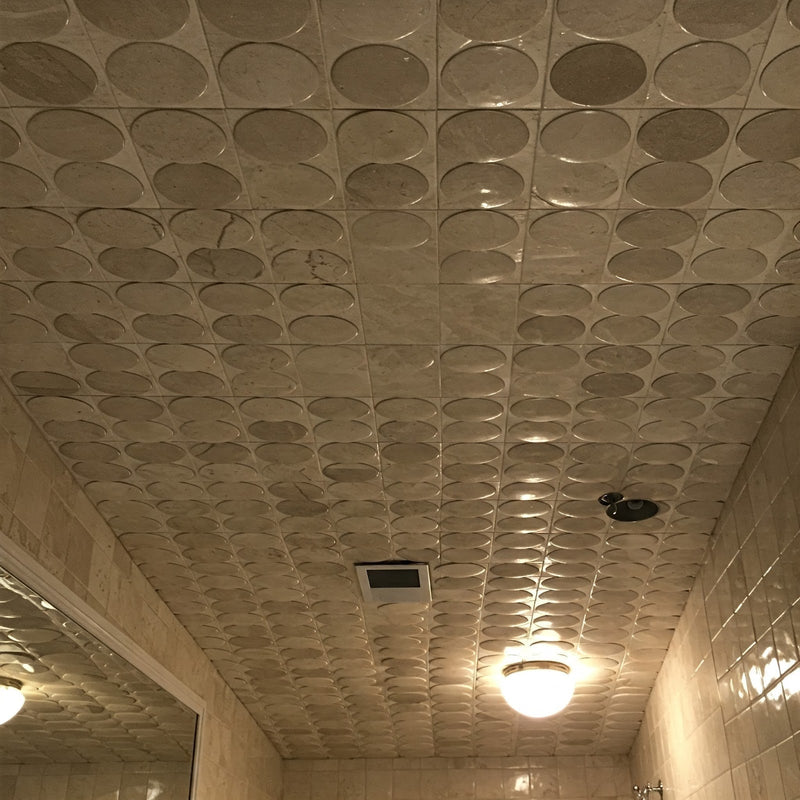 A bathroom ceiling covered with patterned porcelain tile spheres, creating a luxurious and unique look.