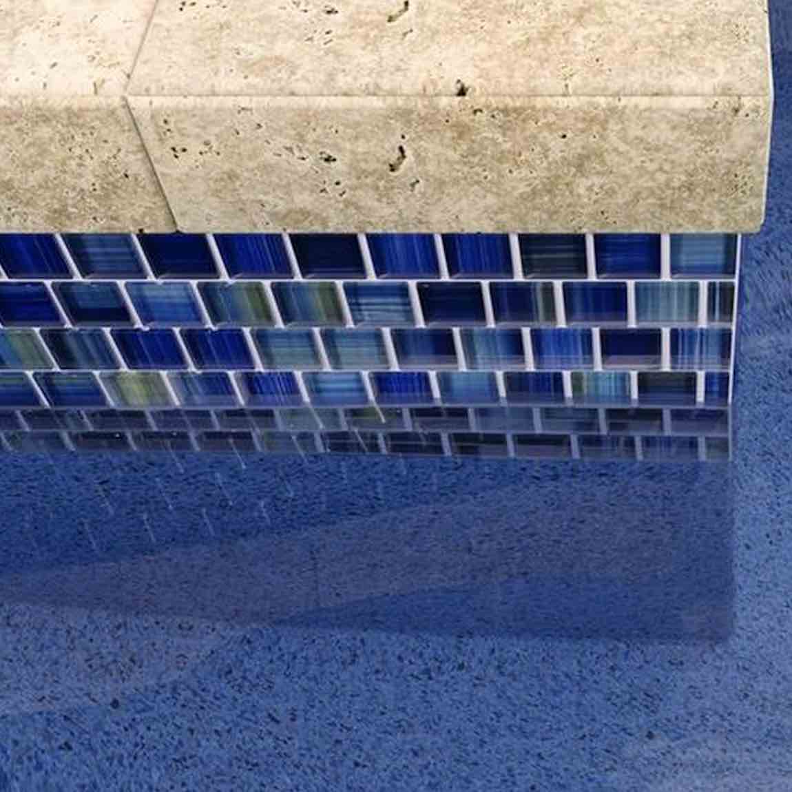 Glass Mosaic Tile Aquarella Blue 1x1 featured on a pool waterline