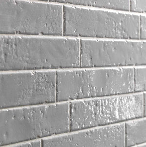 Modern Farmhouse Brick Porcelain Tile Gray 2x9 in a glossy finish