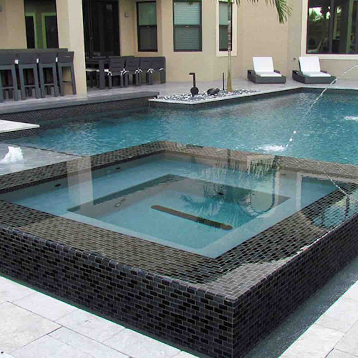 Iridescent Clear Glass Pool Tile Dark Blend 1''x2'' featured on a swimming pool waterline and spa