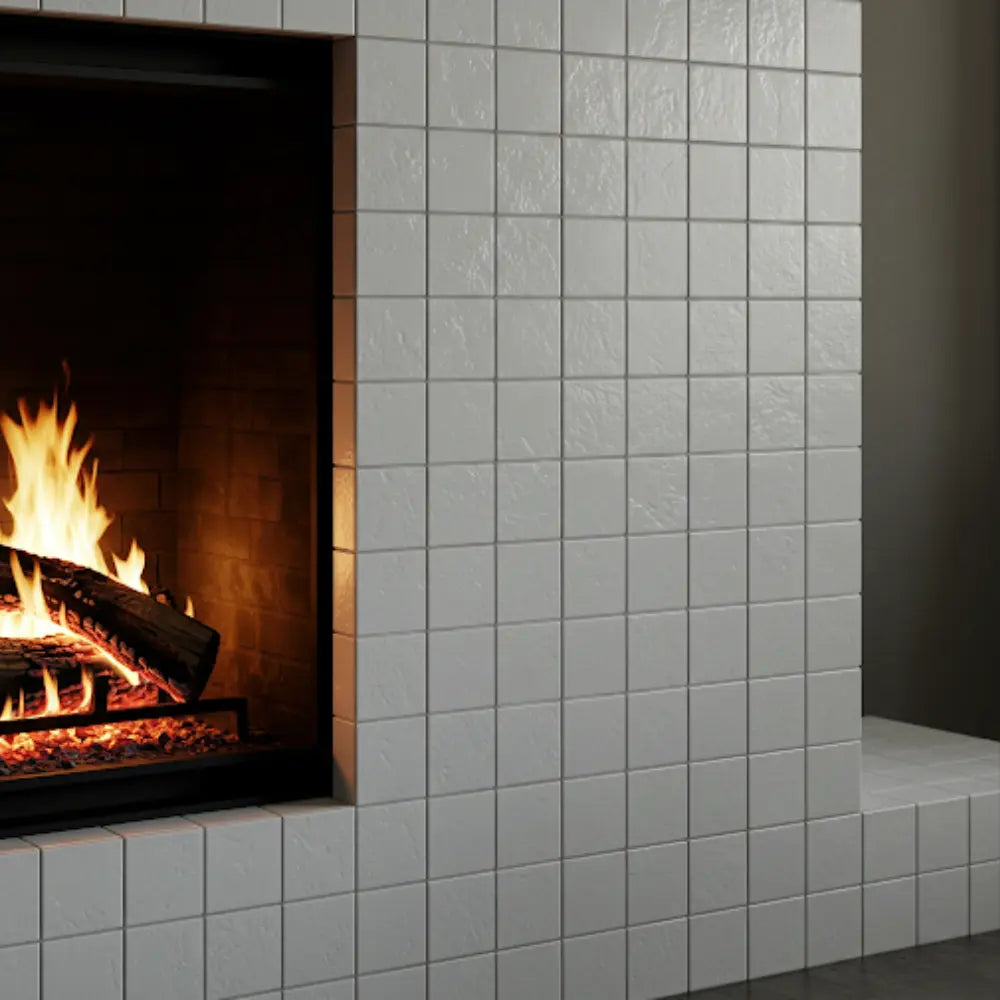 White Matte Porcelain Mosaic Tile is used around a cozy fireplace, enhancing the elegant ambiance