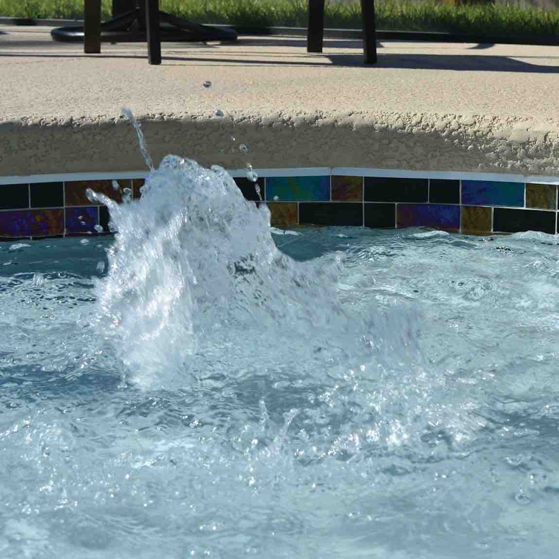 Swimming Pool waterline featuring a black iridescent glass tile by Mineral Tiles