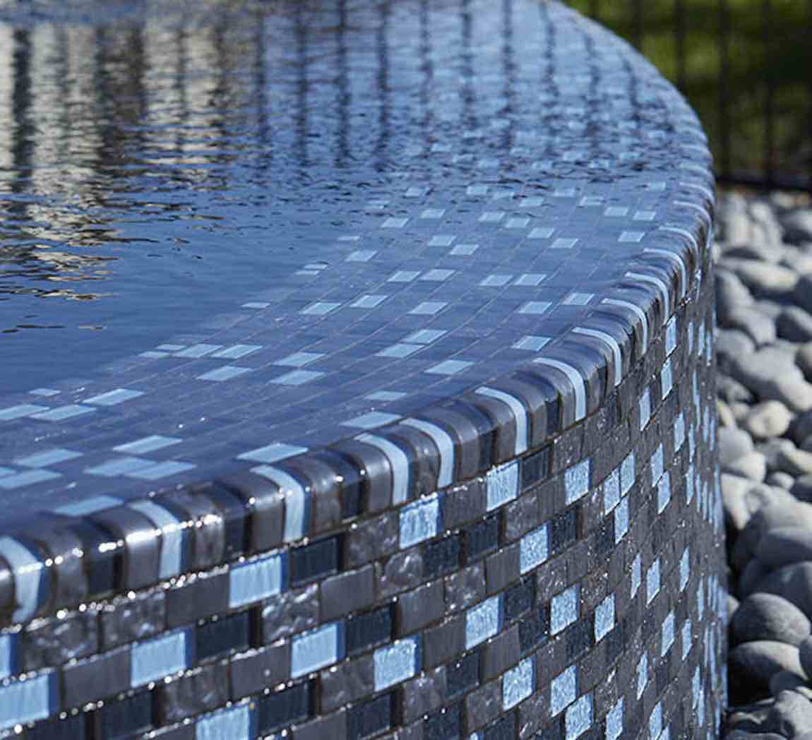 Glass Pool Mosaic Tile Blue Blend 1x2 installed on a infinity pool wall